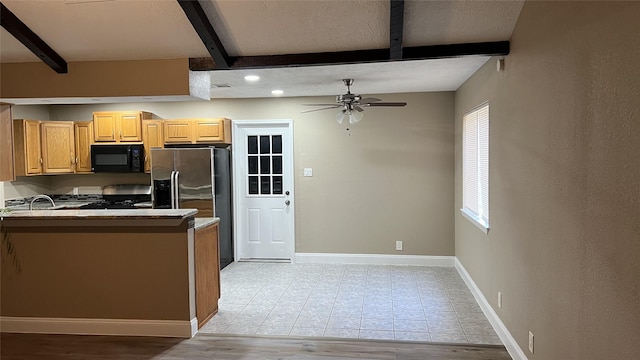 kitchen featuring appliances with stainless steel finishes, sink, ceiling fan, beam ceiling, and light hardwood / wood-style flooring