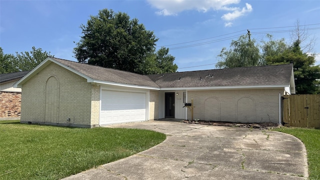 ranch-style house with a garage and a front lawn