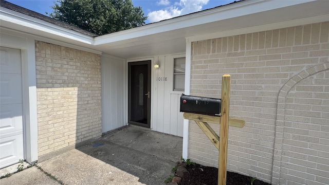 view of exterior entry featuring a garage