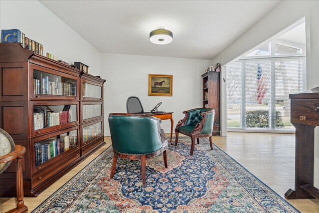 home office with light hardwood / wood-style floors