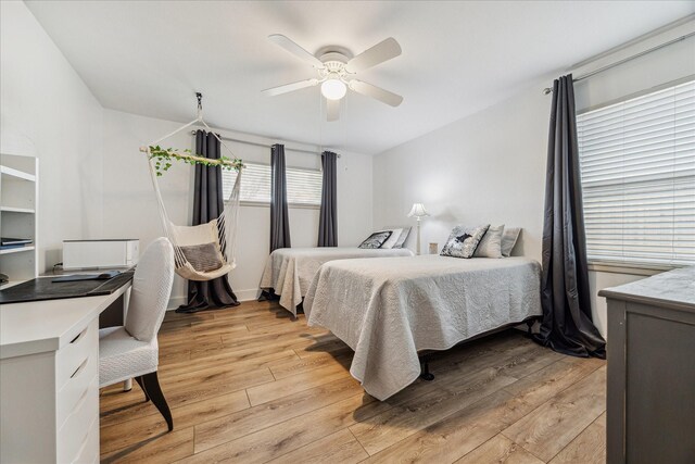 bedroom featuring light hardwood / wood-style floors and ceiling fan