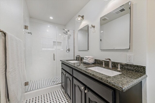 bathroom featuring vanity and a shower with door