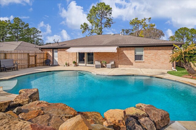 view of pool featuring a patio