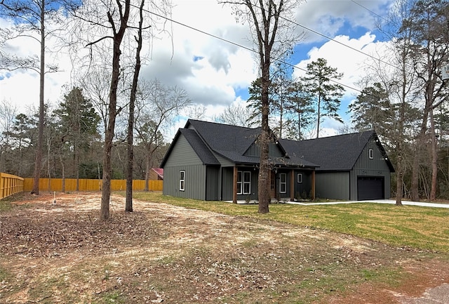 view of front of property with a garage and a front lawn