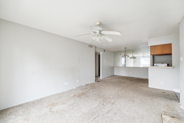 unfurnished living room with light carpet and ceiling fan