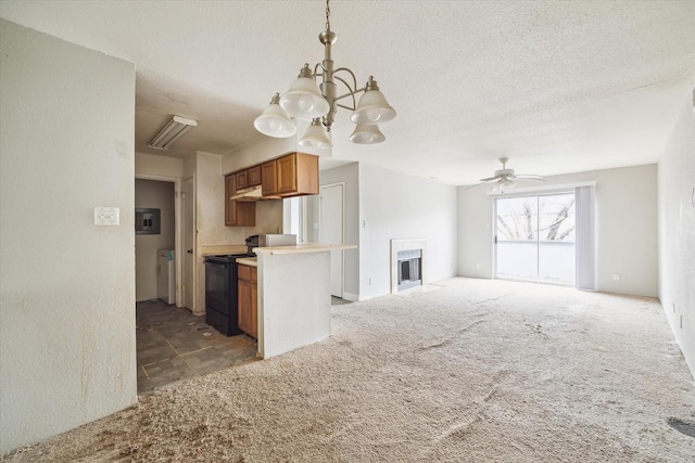 kitchen with pendant lighting, dark carpet, black range with electric cooktop, and a textured ceiling