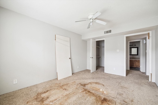 unfurnished bedroom featuring light colored carpet and ceiling fan