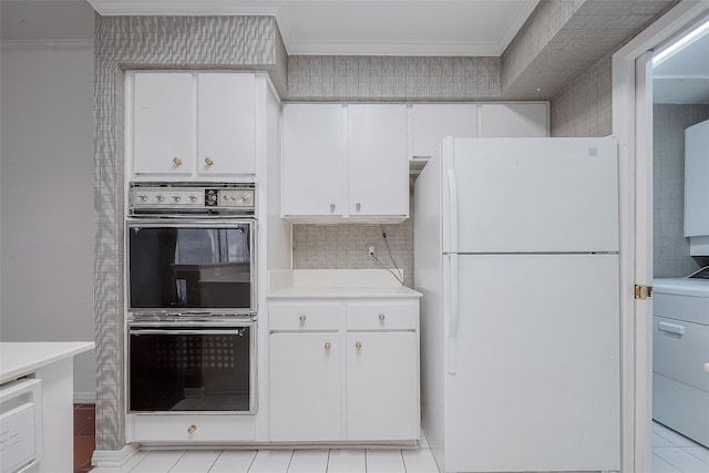 kitchen with white refrigerator, white cabinetry, double wall oven, and washer / dryer