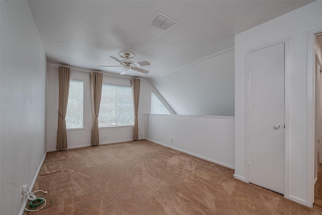 bonus room with lofted ceiling, light carpet, and ceiling fan