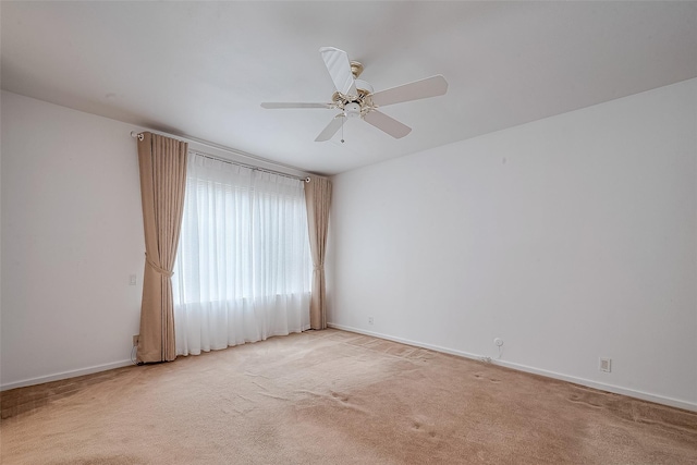 unfurnished room featuring light colored carpet and ceiling fan