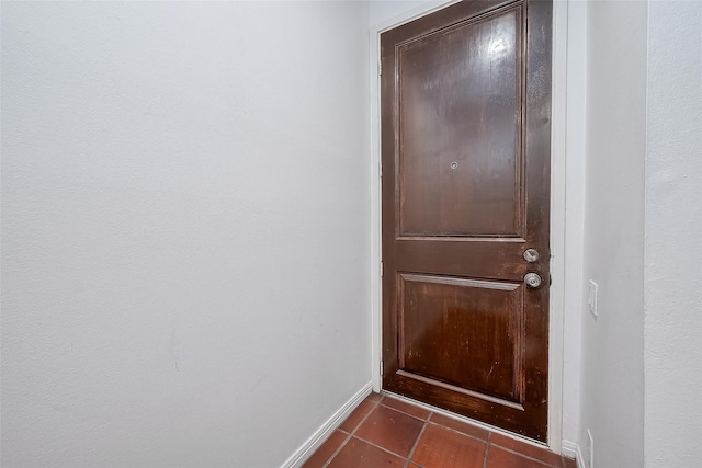 entryway featuring dark tile patterned flooring