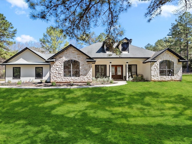 back of property with a yard and french doors