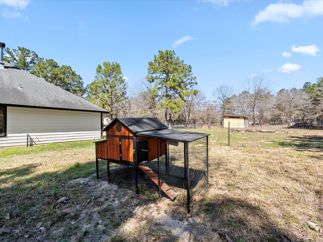 view of yard featuring an outbuilding and exterior structure