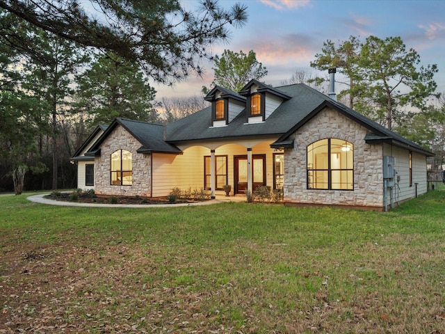 view of front of property with stone siding and a front lawn