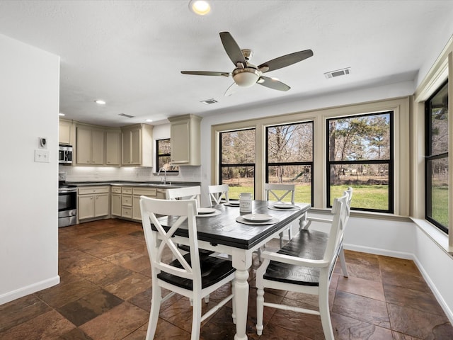 dining space featuring stone tile floors, visible vents, recessed lighting, and baseboards