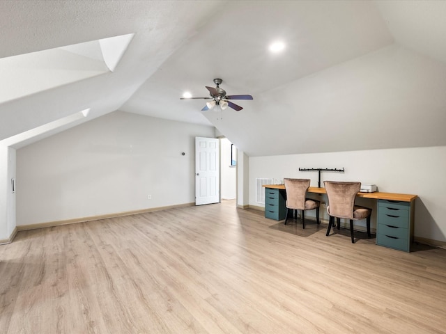 office space with light wood finished floors, visible vents, baseboards, and lofted ceiling