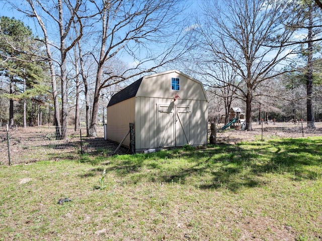 view of shed featuring a playground and fence