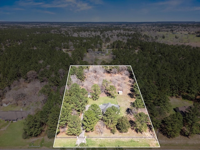 drone / aerial view with a wooded view