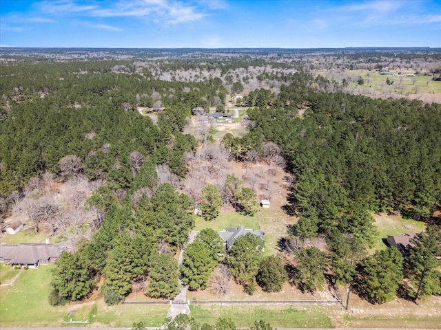 drone / aerial view featuring a wooded view