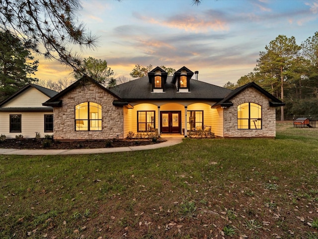 french country home with a lawn and french doors