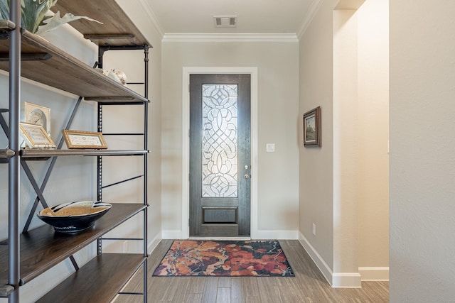 foyer entrance with hardwood / wood-style flooring, ornamental molding, and plenty of natural light