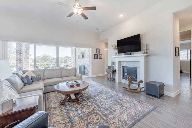 living room with ceiling fan and light wood-type flooring