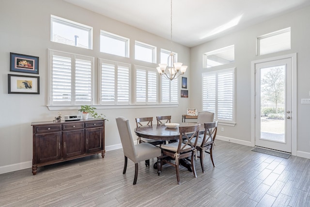 dining room with a chandelier and light hardwood / wood-style flooring