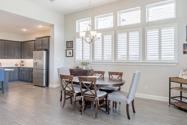 dining area featuring an inviting chandelier and light hardwood / wood-style floors