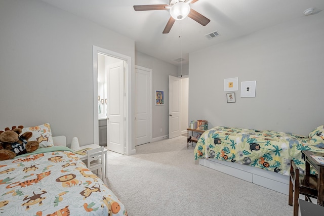 carpeted bedroom with connected bathroom and ceiling fan