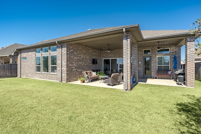 back of house featuring ceiling fan, outdoor lounge area, a patio, and a lawn