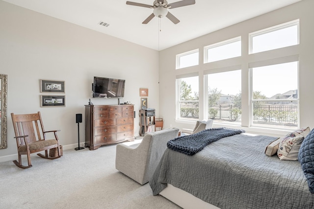 bedroom featuring light carpet and ceiling fan