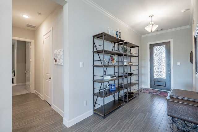 entryway featuring dark hardwood / wood-style flooring and ornamental molding