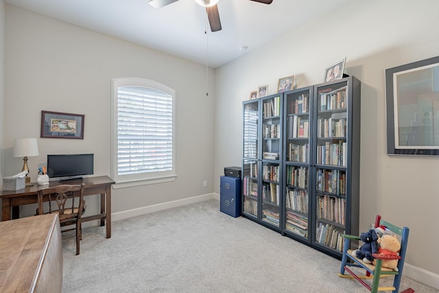 home office with light carpet and ceiling fan