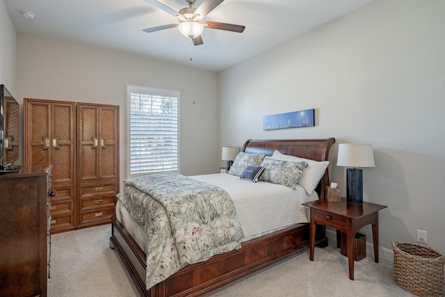 bedroom featuring light carpet and ceiling fan