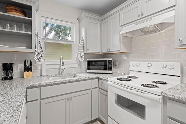 kitchen with tasteful backsplash, sink, white cabinets, white range with electric cooktop, and light stone countertops