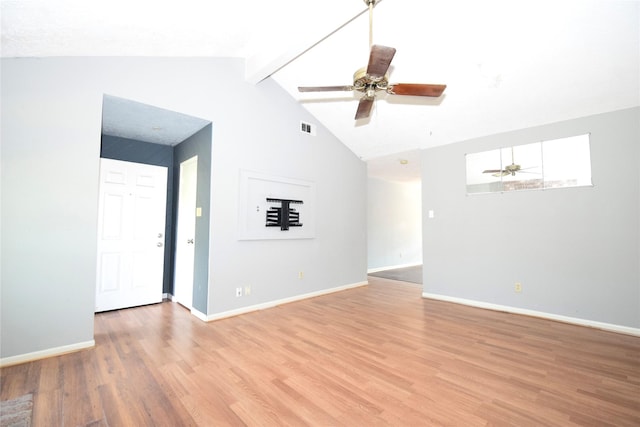 empty room featuring hardwood / wood-style flooring, ceiling fan, and lofted ceiling with beams