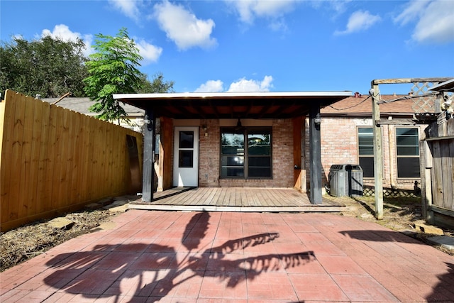 rear view of house with a patio and a wooden deck