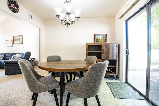 dining space featuring an inviting chandelier and carpet flooring