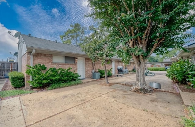 view of front of home with central AC unit and a patio