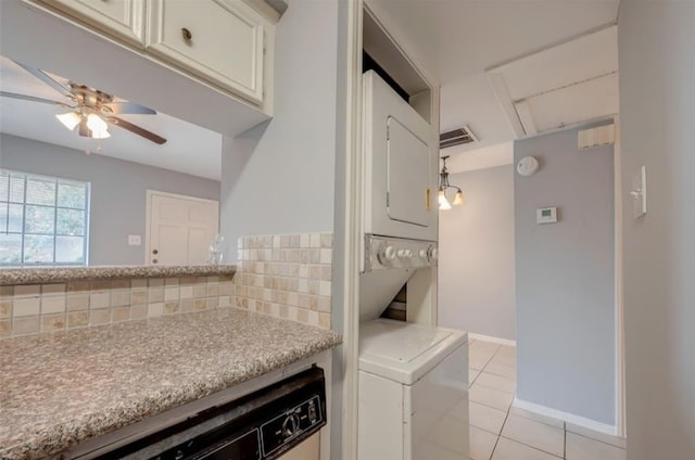 kitchen with tasteful backsplash, stacked washer and dryer, light tile patterned floors, and ceiling fan