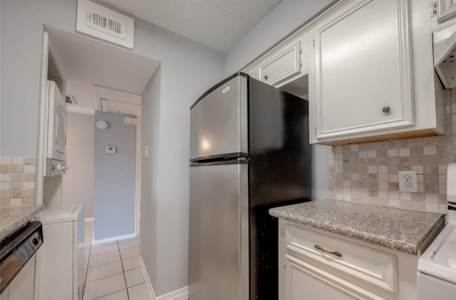 kitchen featuring white cabinetry, decorative backsplash, stainless steel appliances, and light tile patterned flooring