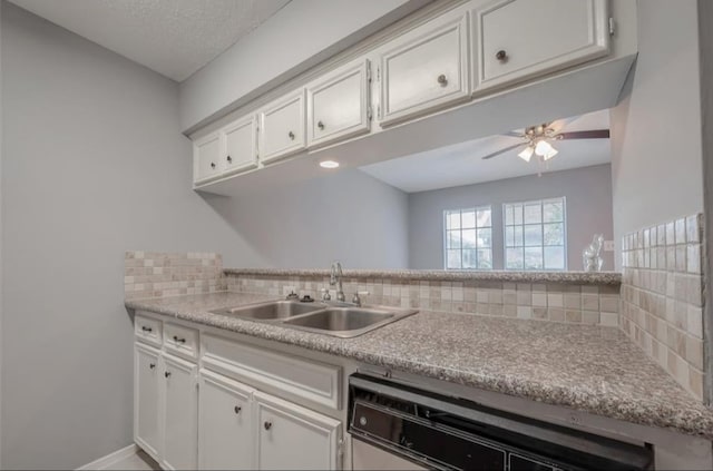 kitchen featuring sink, white cabinetry, stainless steel dishwasher, ceiling fan, and decorative backsplash