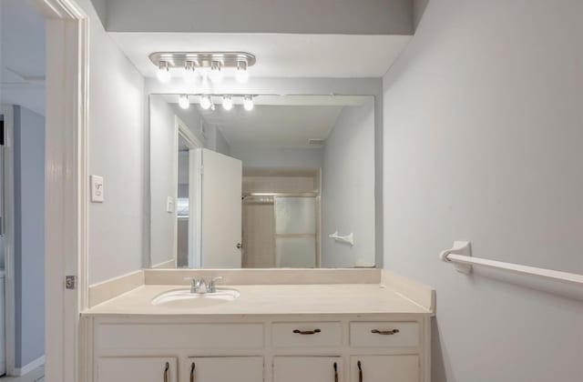 bathroom with vanity and a shower with shower door