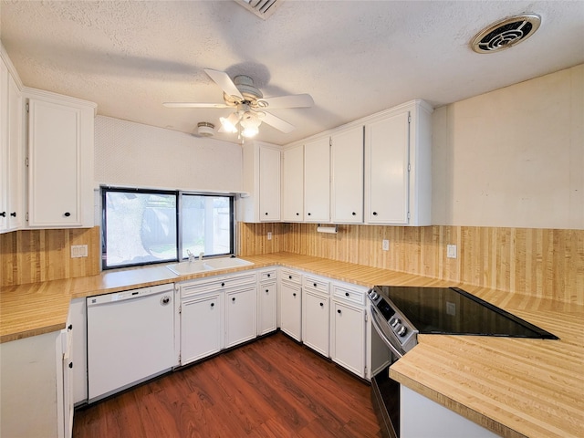 kitchen with sink, dishwasher, electric range, white cabinets, and dark hardwood / wood-style flooring