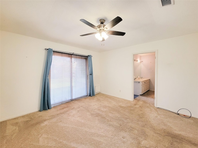 unfurnished bedroom featuring ceiling fan, connected bathroom, and light carpet