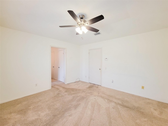 carpeted empty room featuring ceiling fan