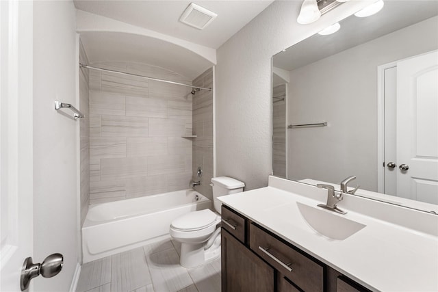 full bath featuring visible vents, a textured wall, toilet, tub / shower combination, and vanity