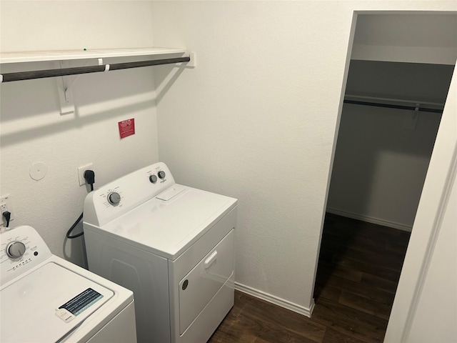 laundry area featuring washer and dryer and dark hardwood / wood-style floors