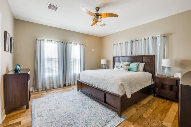 bedroom with ceiling fan and light wood-type flooring