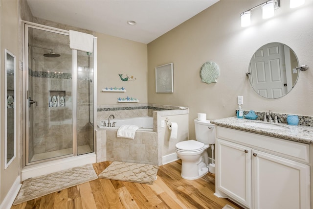 full bathroom featuring hardwood / wood-style flooring, vanity, plus walk in shower, and toilet